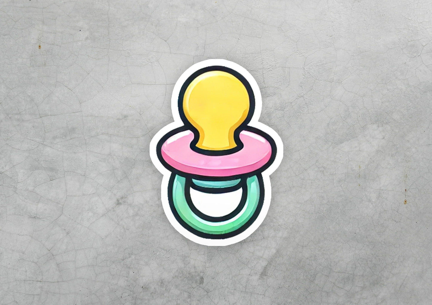 a sticker of a pacifier on a concrete surface