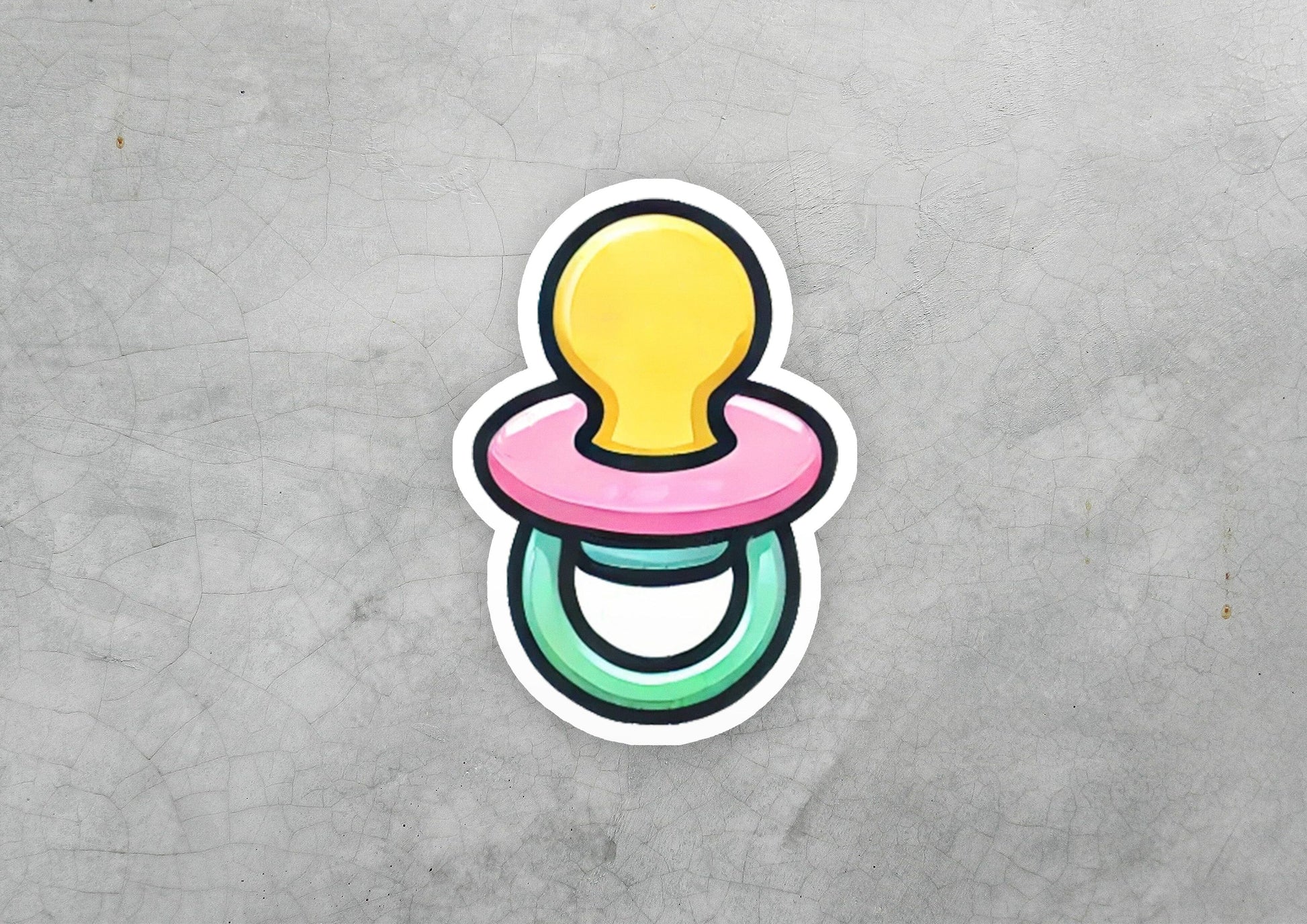a sticker of a pacifier on a concrete surface