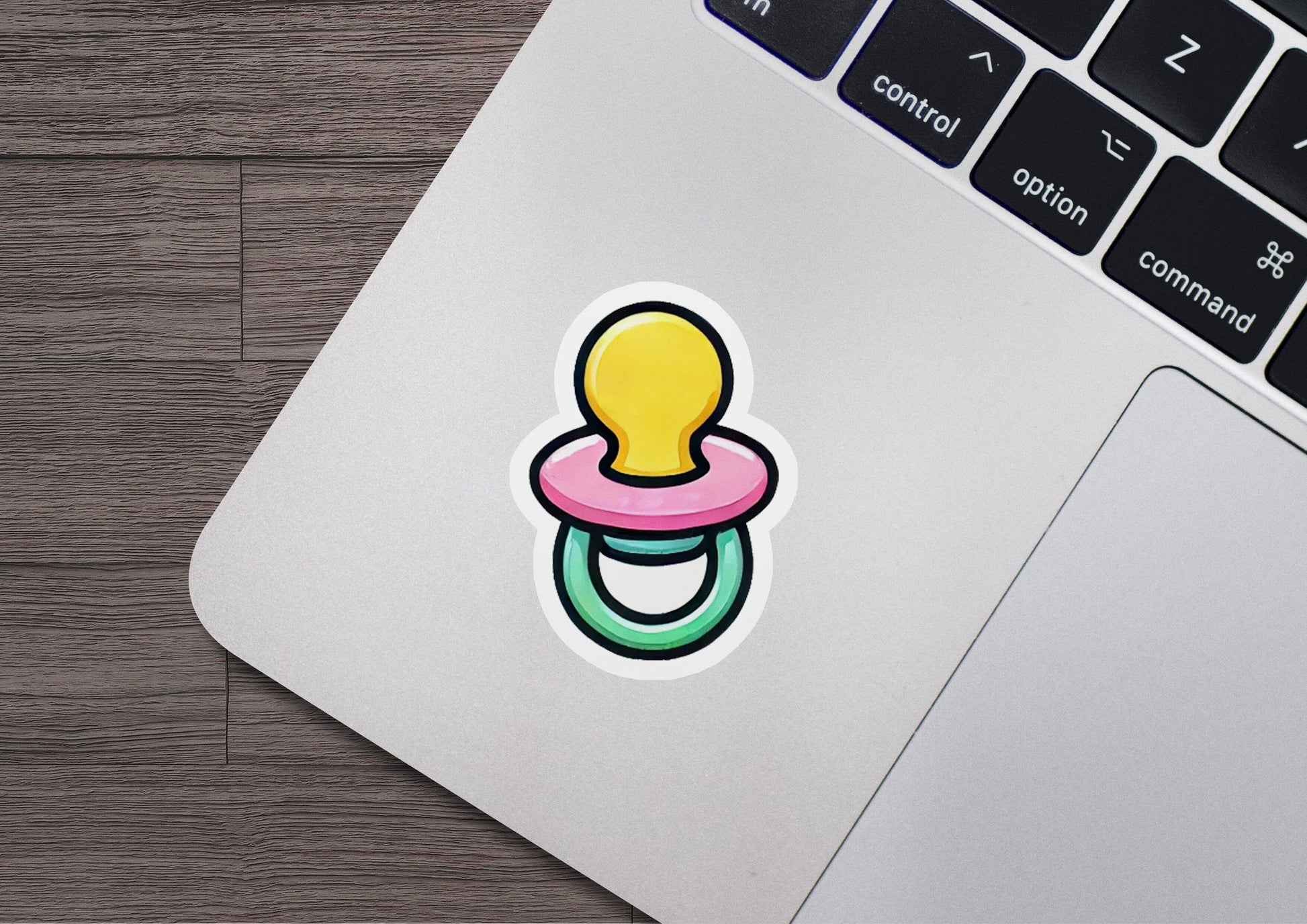 a laptop with a sticker of a pacifier
