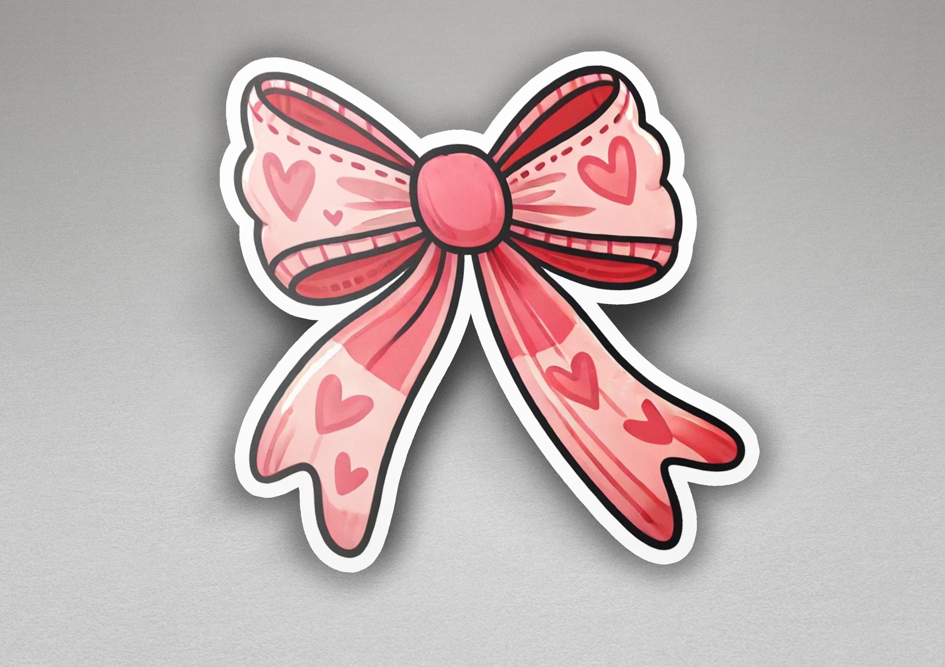 a sticker of a pink bow with hearts on it