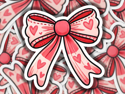 a sticker of a bow with hearts on it