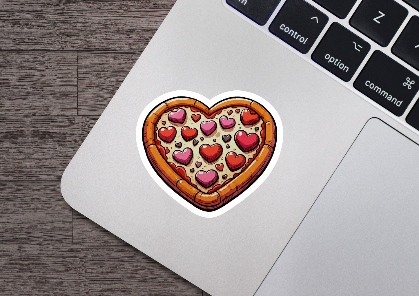 a heart shaped pizza sticker sitting on top of a laptop