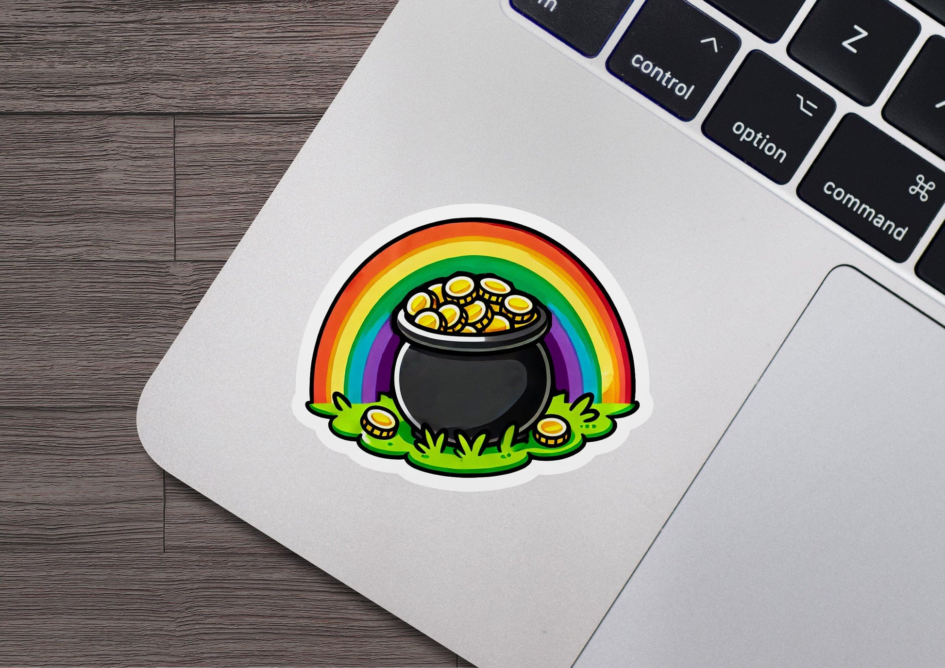 a laptop with a sticker of a pot of gold
