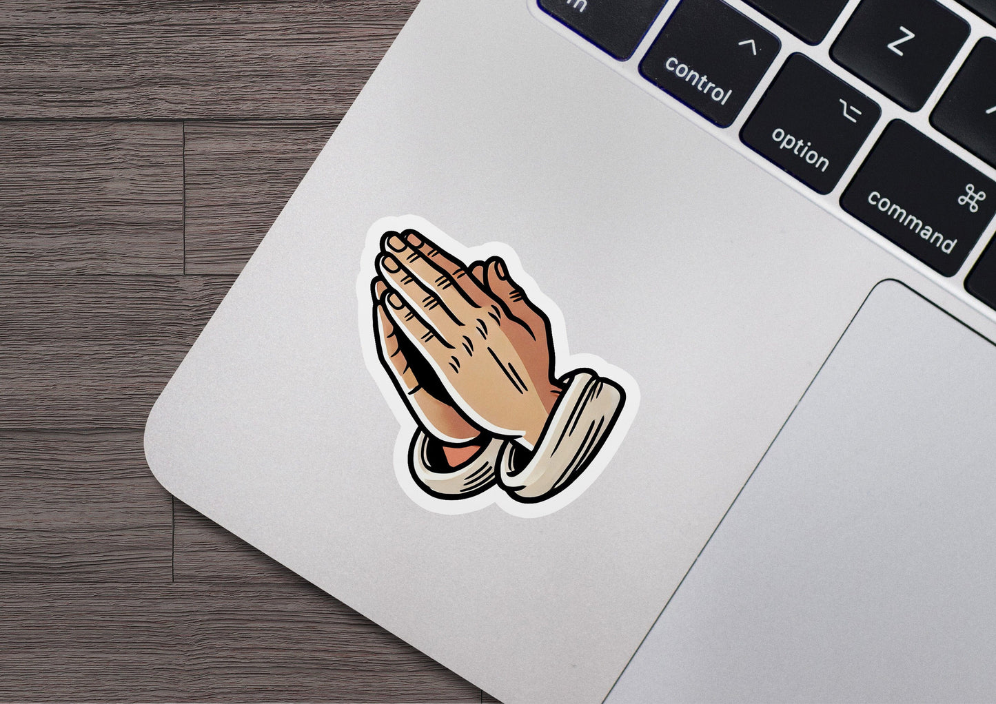 a laptop with a sticker of a praying hand