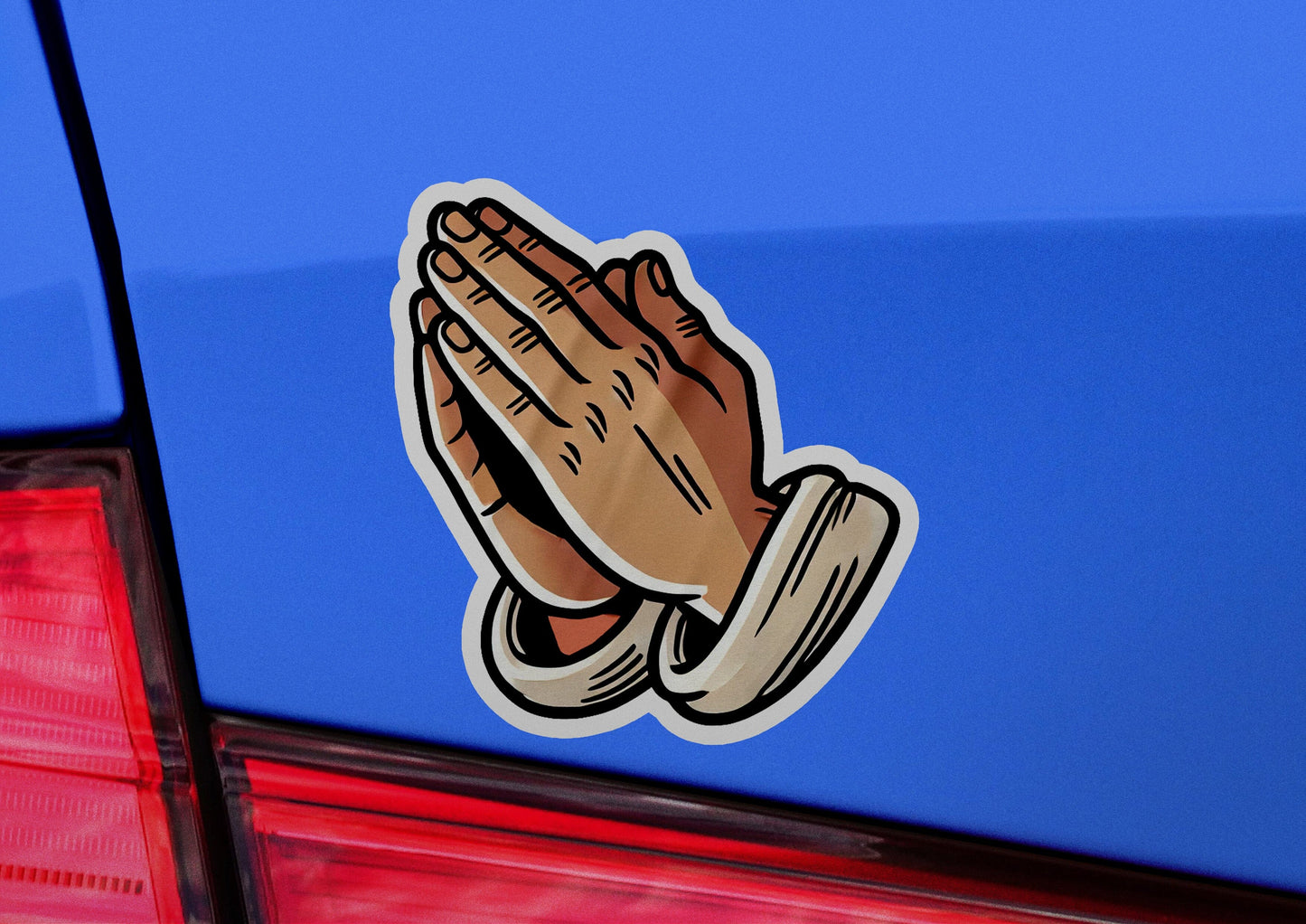 a car with a sticker of a praying hand