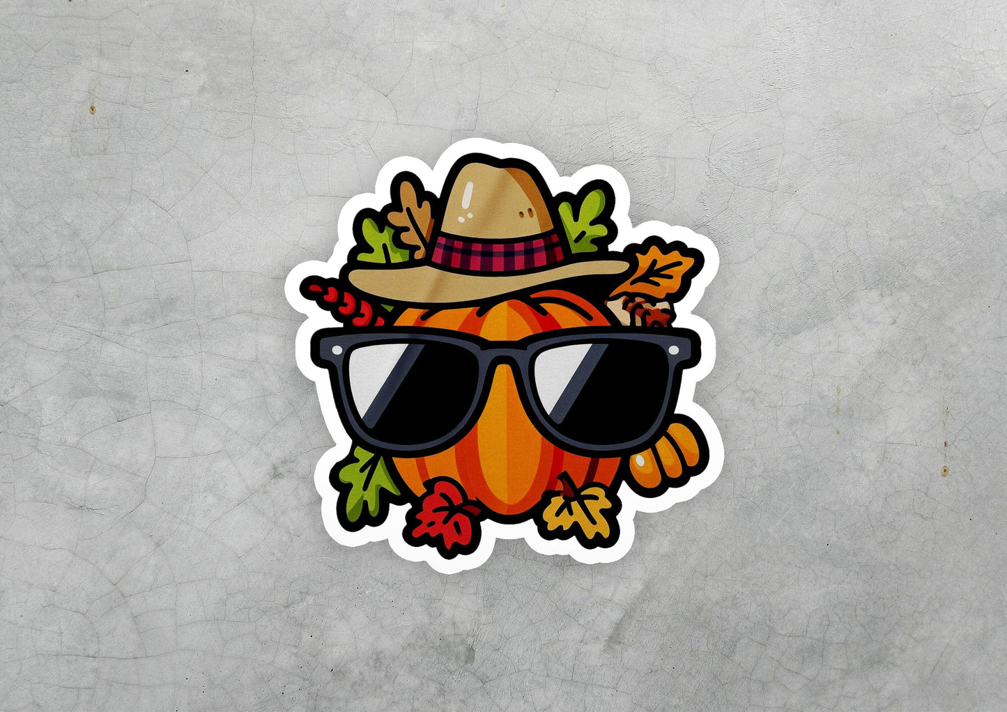 a sticker of a pumpkin wearing sunglasses and a hat