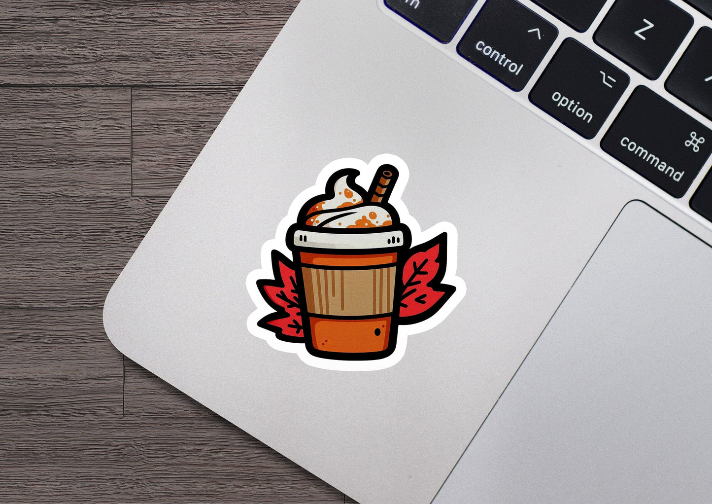 a laptop computer with a sticker of a cup of coffee
