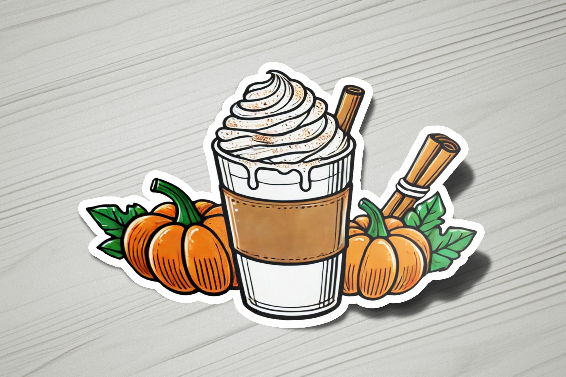 a sticker of a cup of coffee with whipped cream and pumpkins