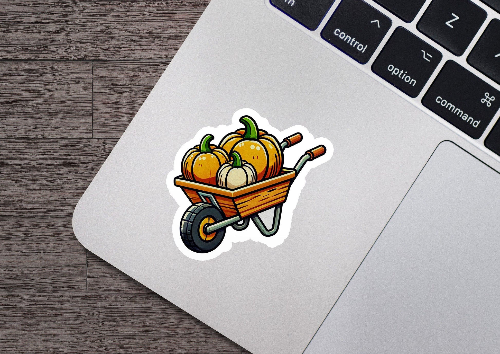 a sticker of a wheelbarrow filled with pumpkins