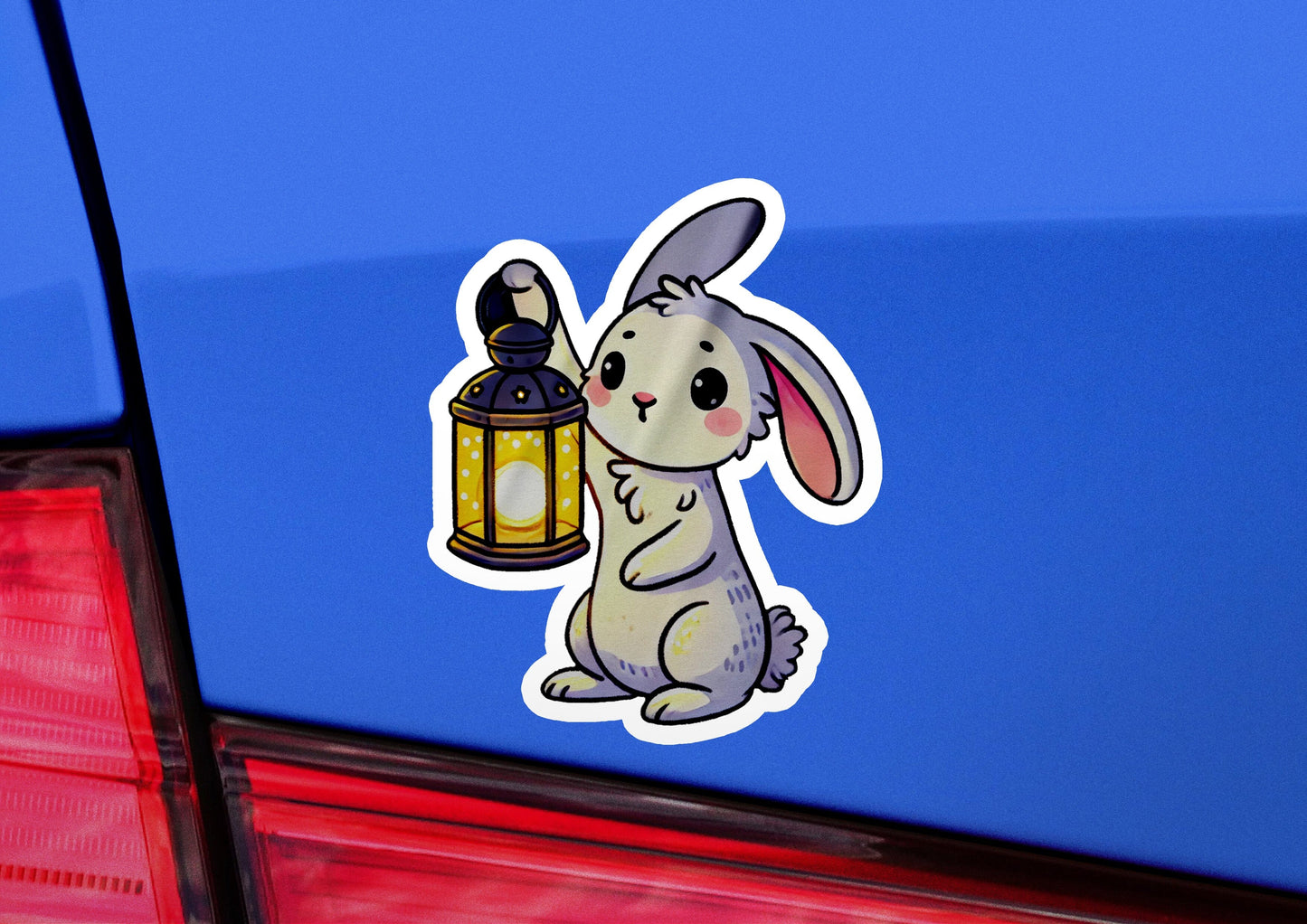 a sticker of a rabbit holding a lantern