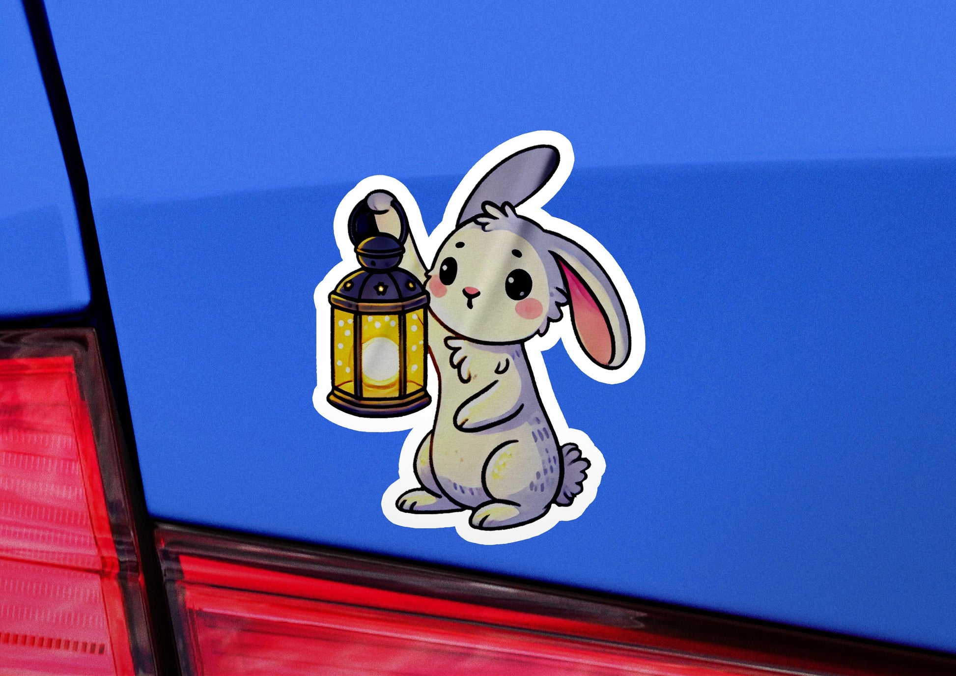 a sticker of a rabbit holding a lantern