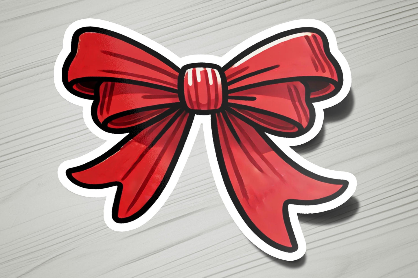 a sticker of a red bow on a wooden surface