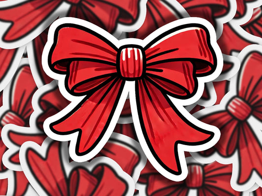 a red bow sticker sitting on top of a pile of red flowers