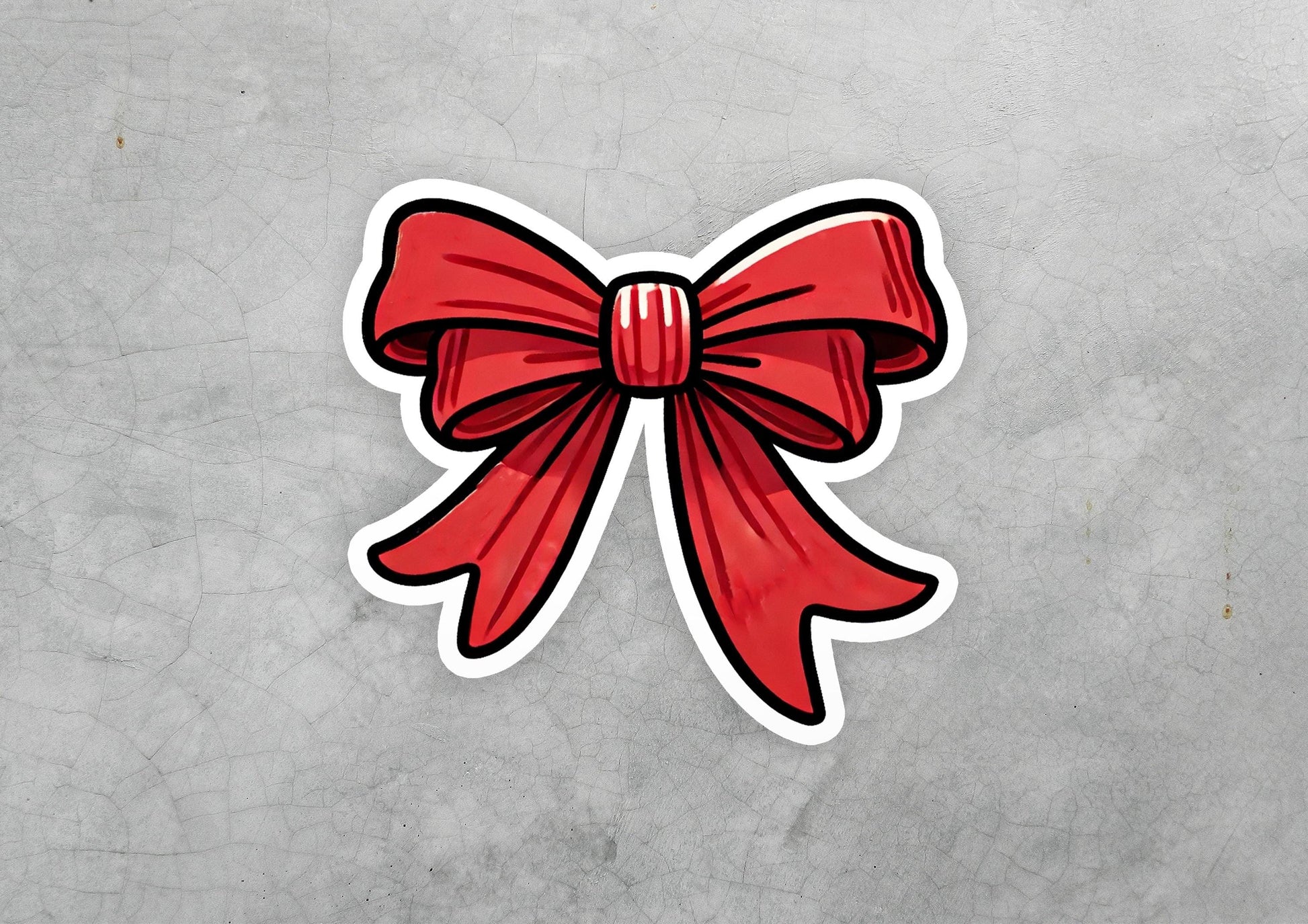 a sticker of a red bow on a gray background