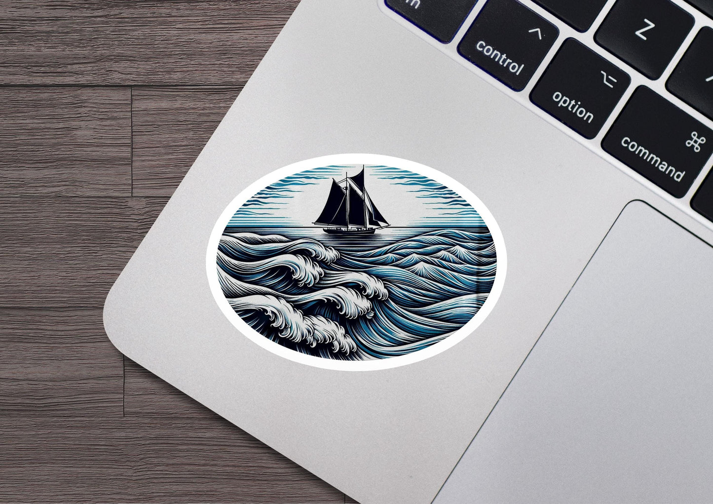 a laptop with a sticker of a boat in the ocean