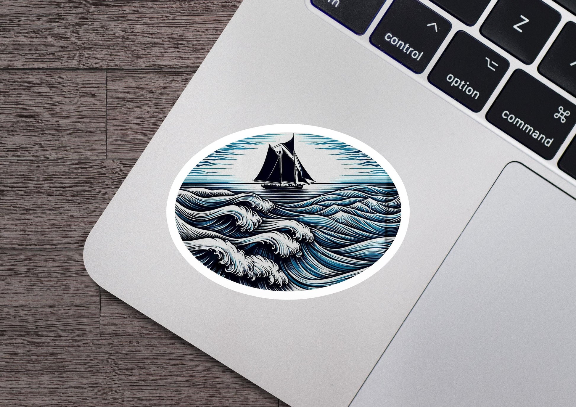 a laptop with a sticker of a boat in the ocean