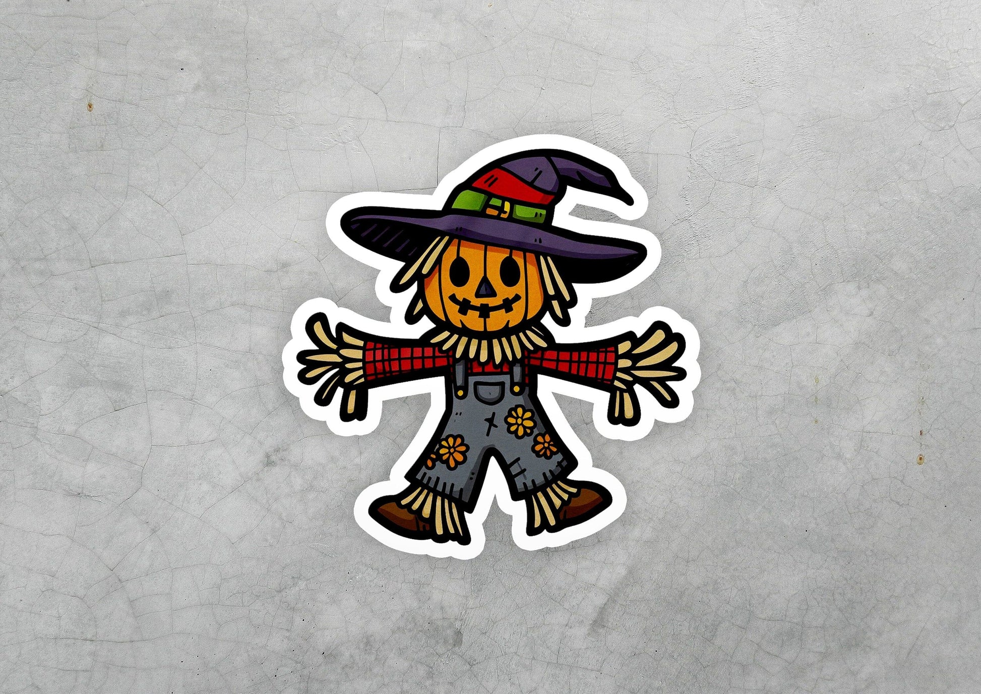 a sticker of a scarecrow wearing a witches hat