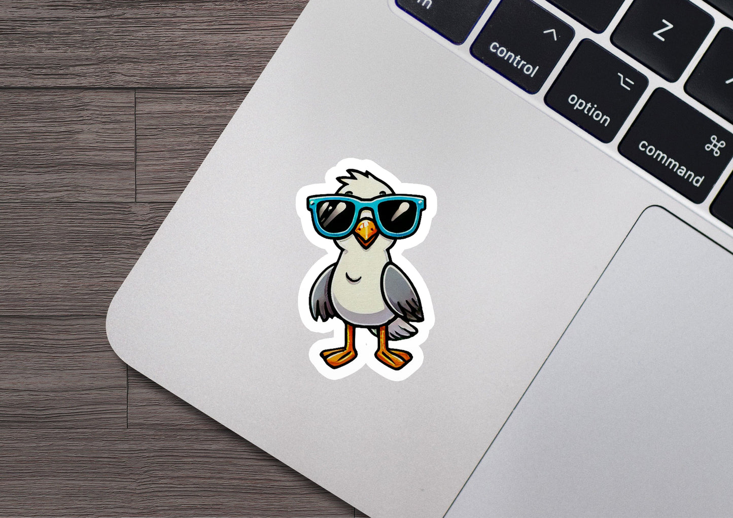 a laptop with a sticker of a bird wearing sunglasses