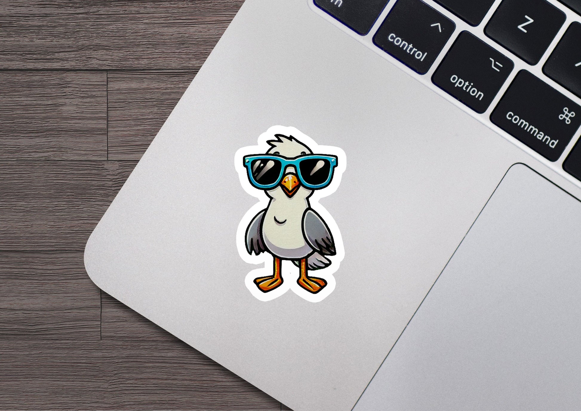 a laptop with a sticker of a bird wearing sunglasses