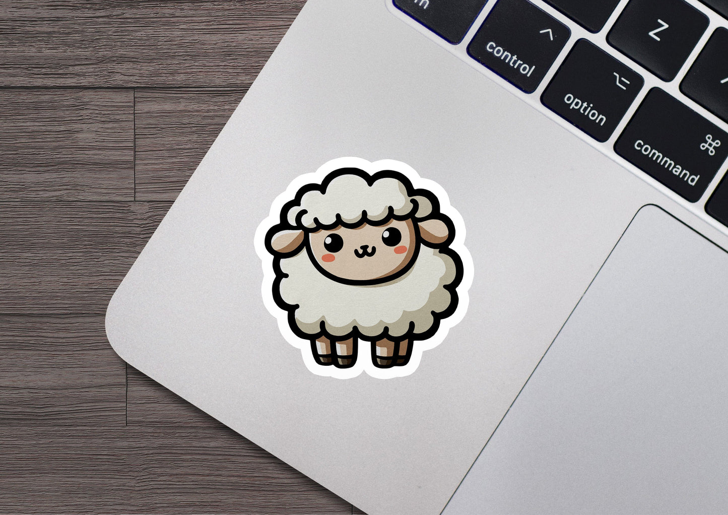 a sticker of a sheep sitting on top of a laptop