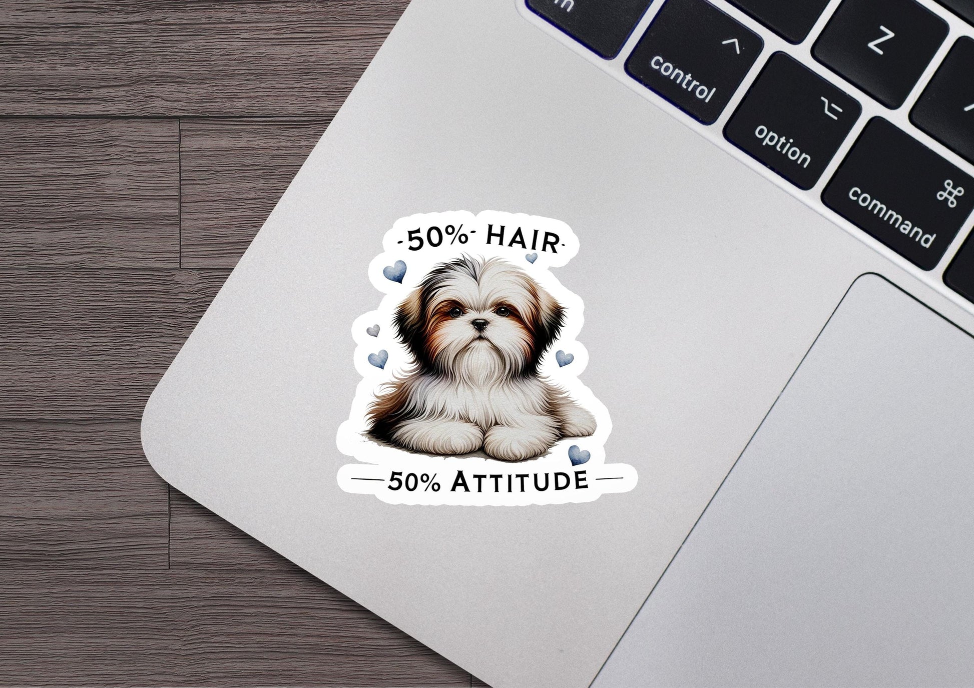 a sticker of a dog sitting on top of a laptop