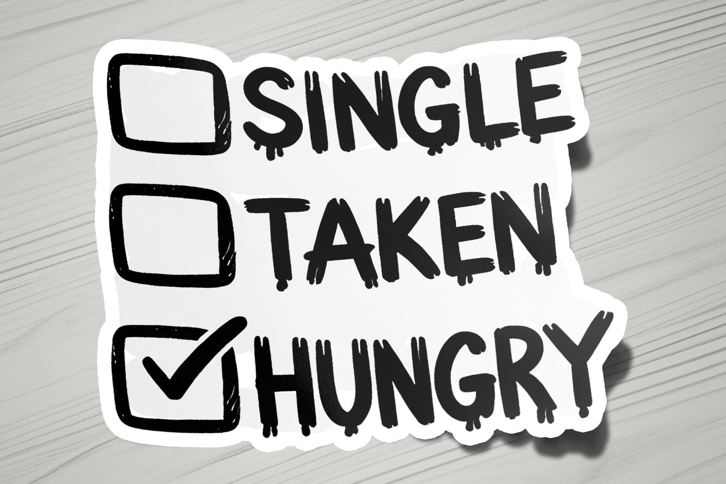 a sticker that says single taken hungry