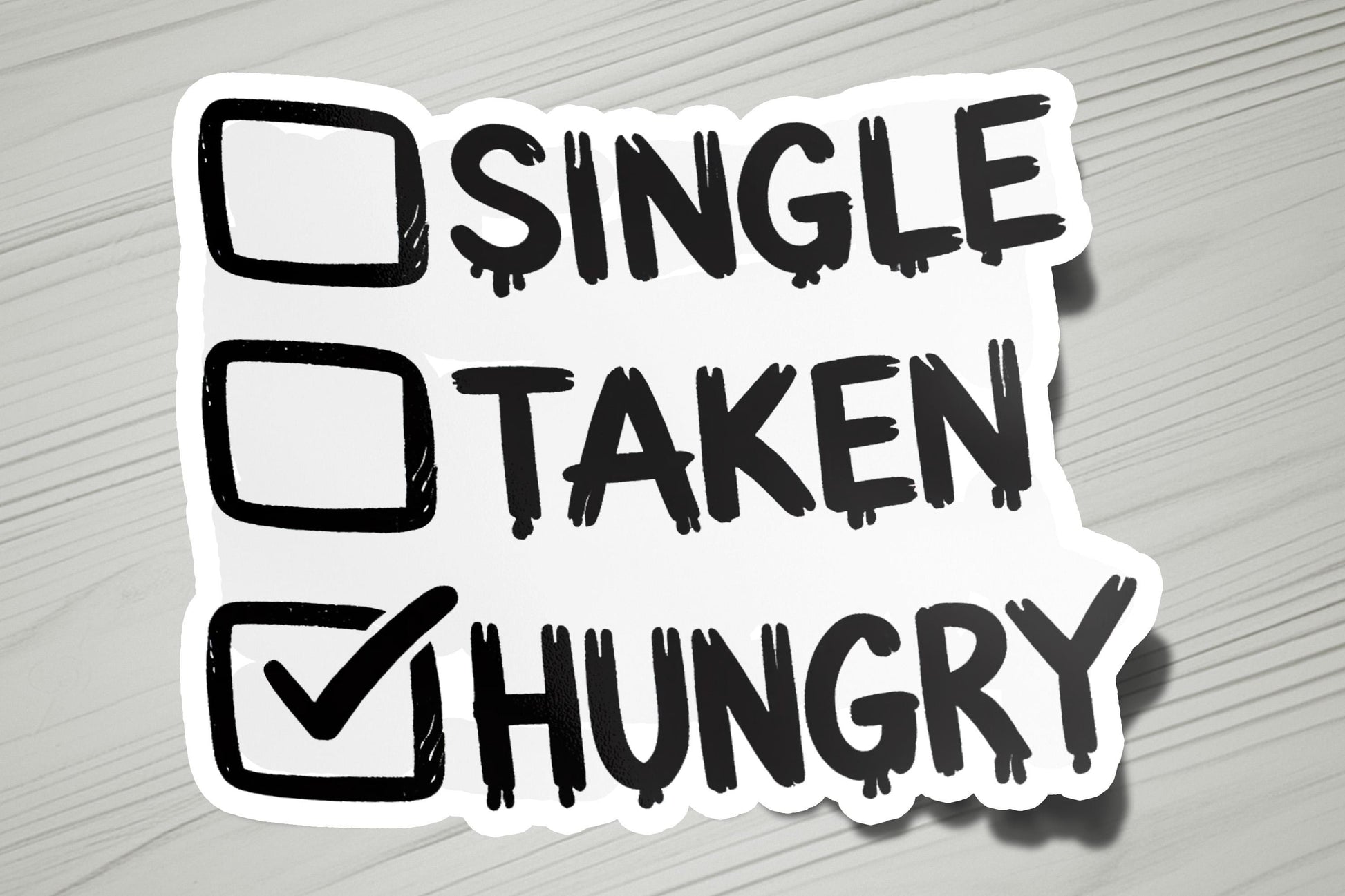 a sticker that says single taken hungry