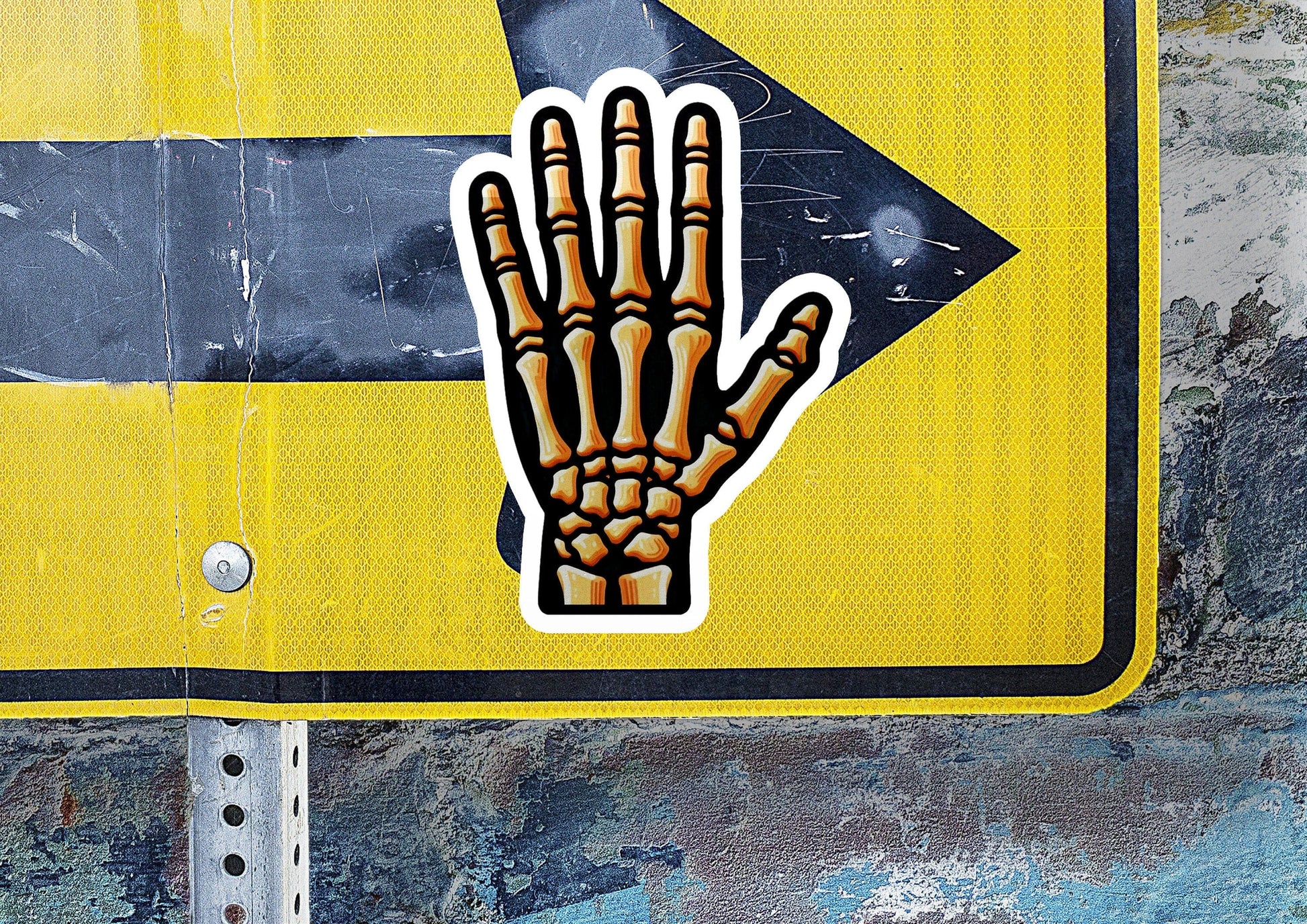 a yellow street sign with a hand painted on it