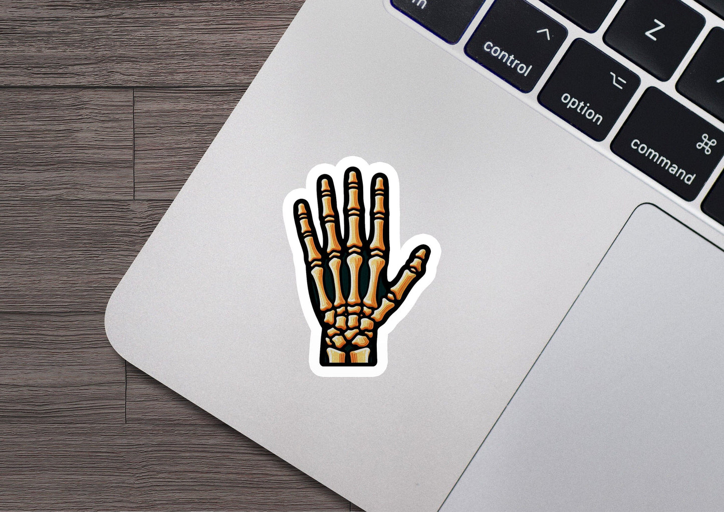 a laptop with a sticker of a hand on it