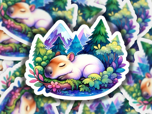 a sticker of a sleeping hamster surrounded by trees