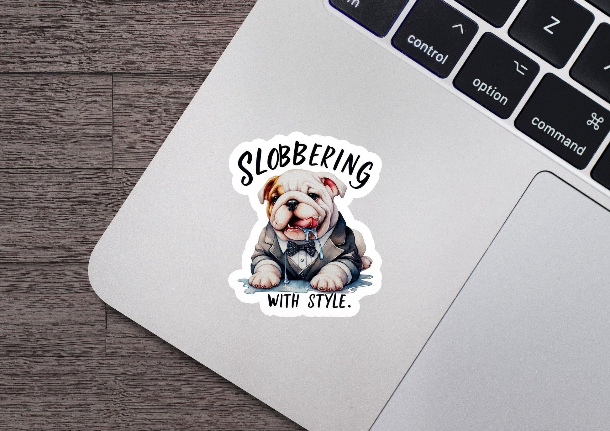 a sticker of a dog sitting on top of a laptop