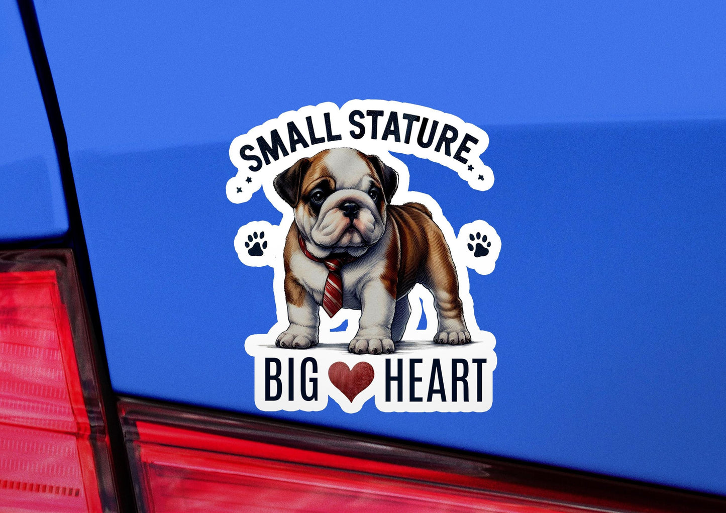 a sticker on the back of a car that says small statue, big heart