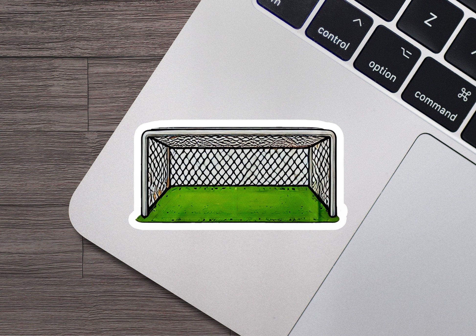 a laptop with a sticker of a soccer goal