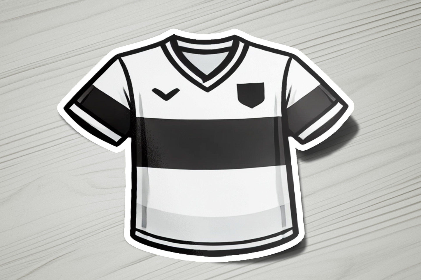 a soccer jersey sticker on a wooden surface
