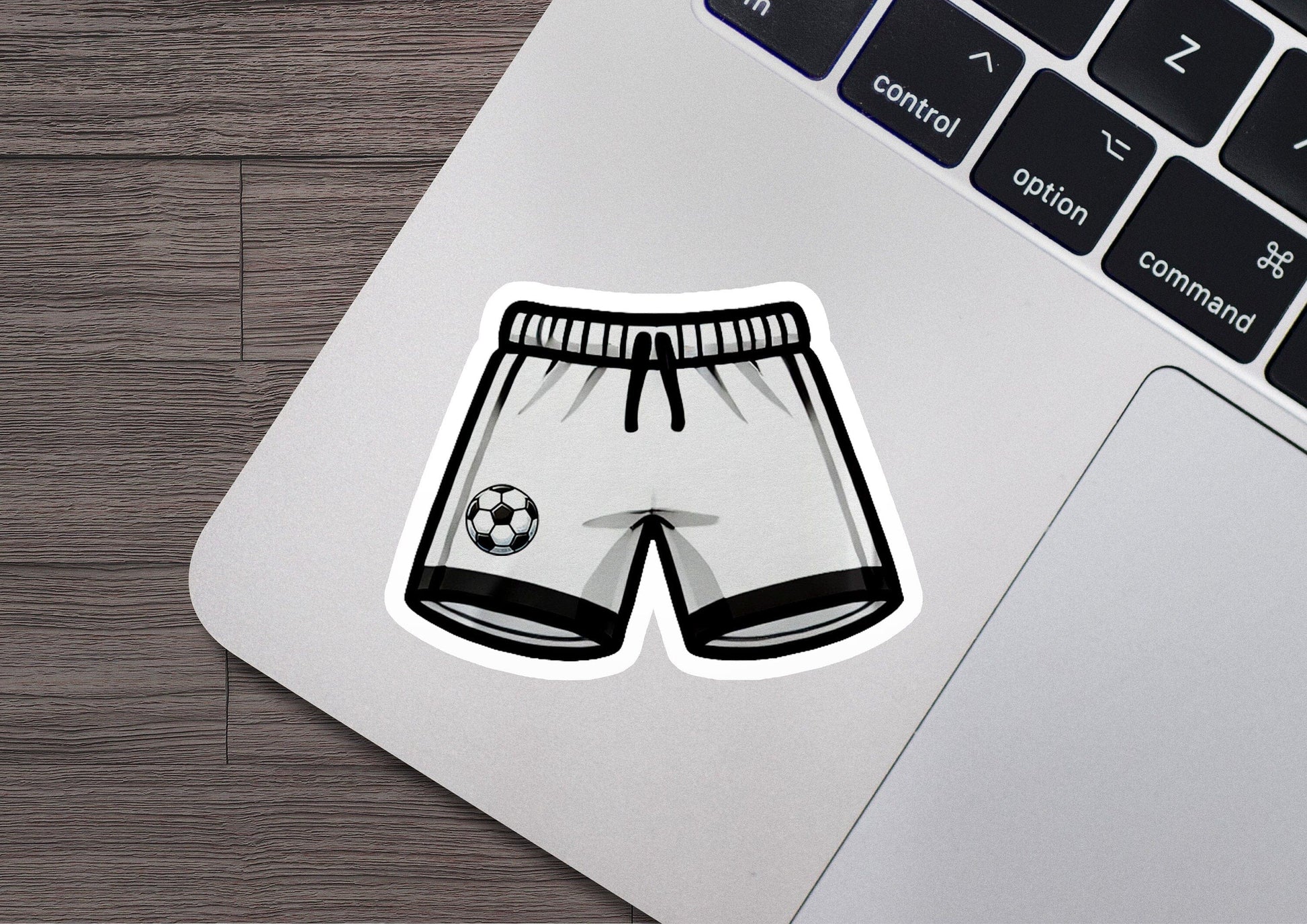 a laptop with a sticker of a soccer shorts