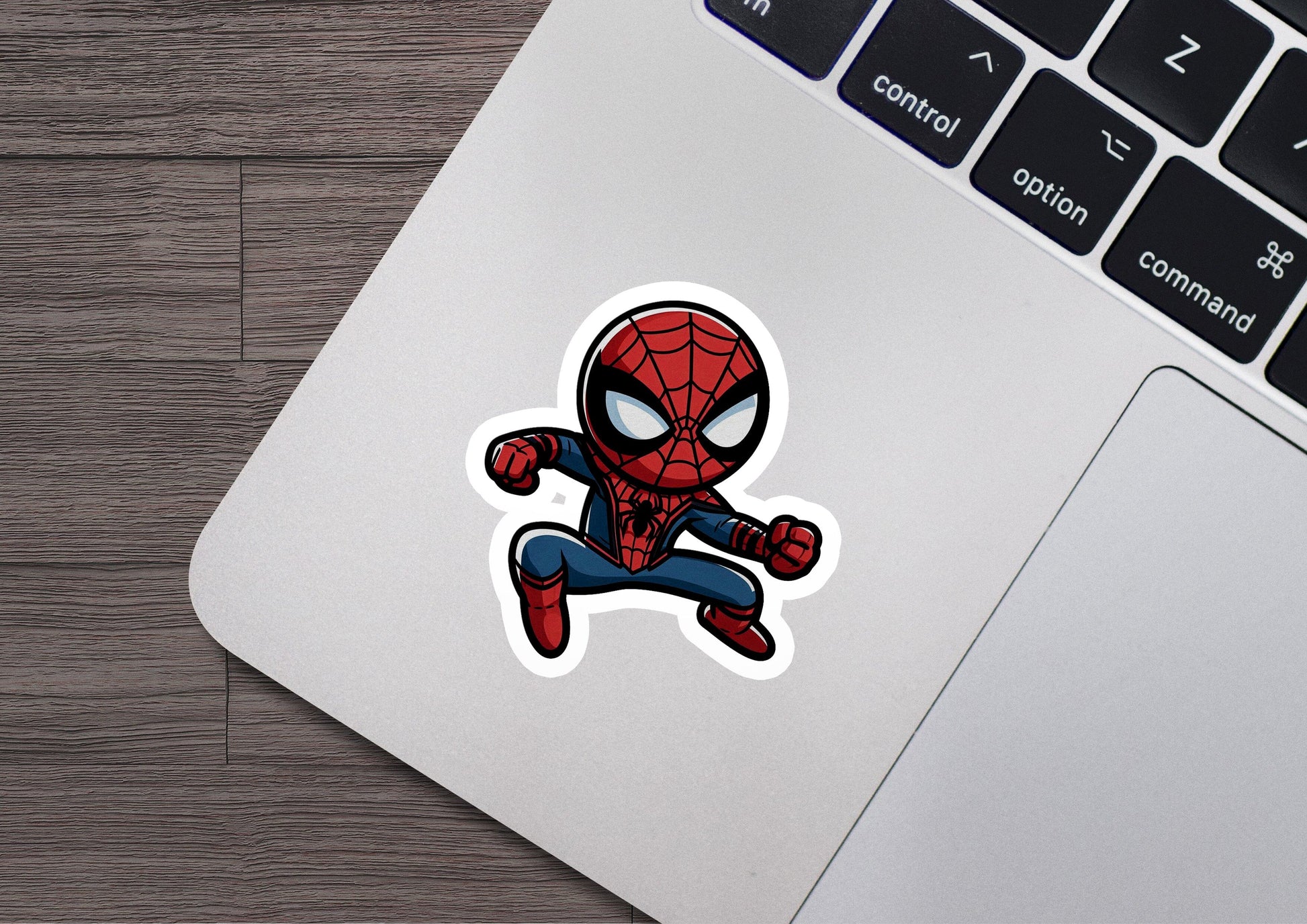 a laptop with a sticker of a spider man