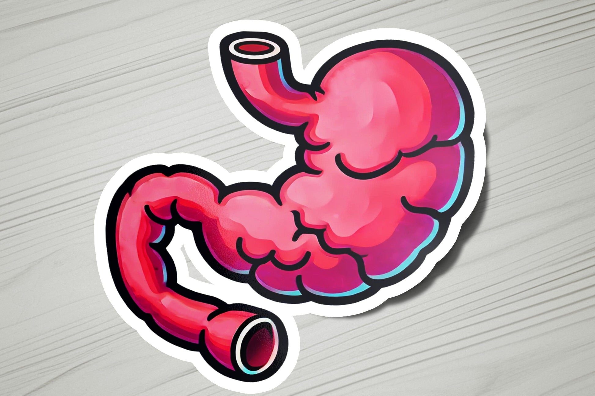 a sticker of a pink stomach on a wooden surface