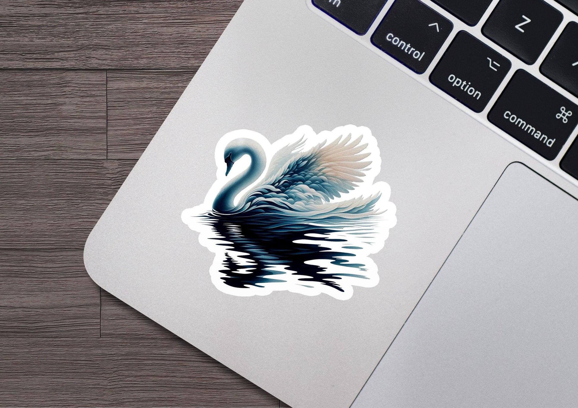 a sticker of a swan on a laptop