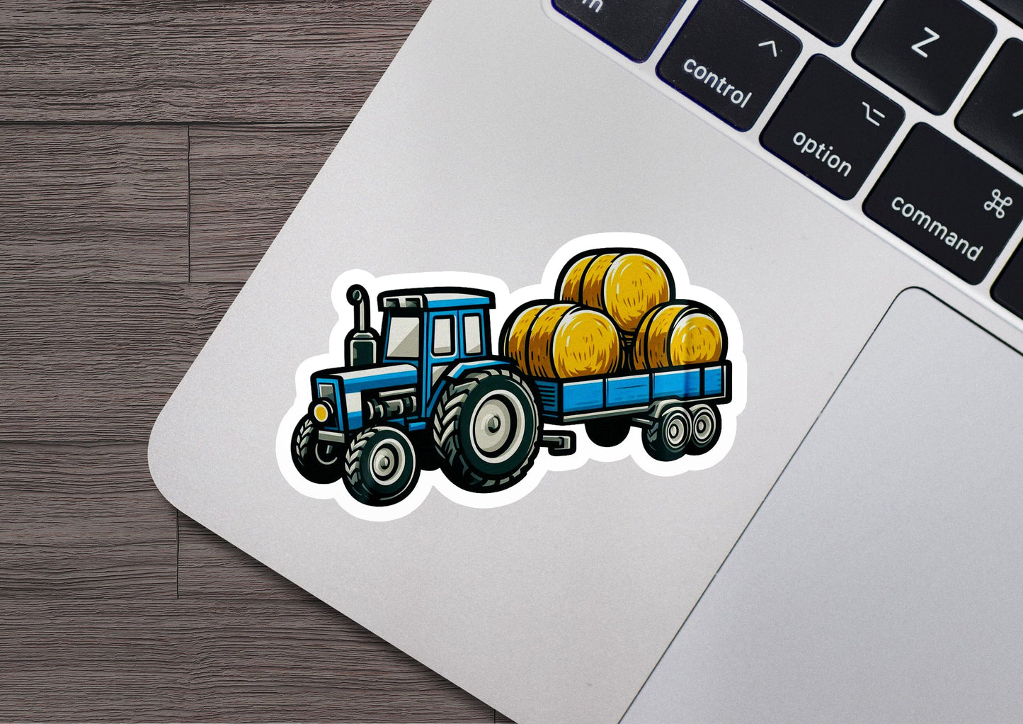 a sticker of a tractor with bales of hay