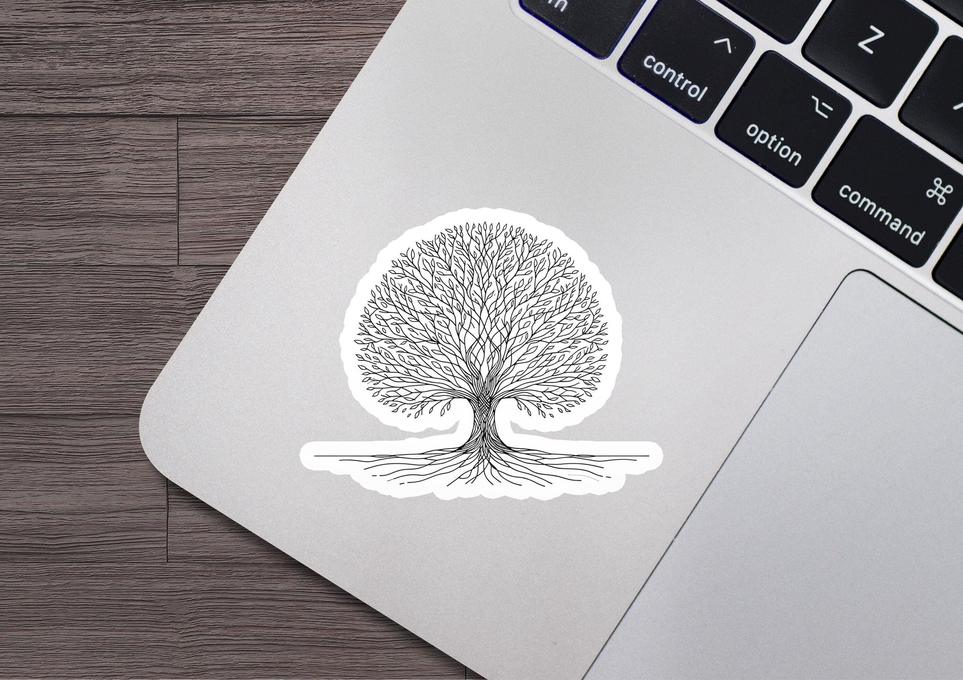 a laptop with a sticker of a tree on it