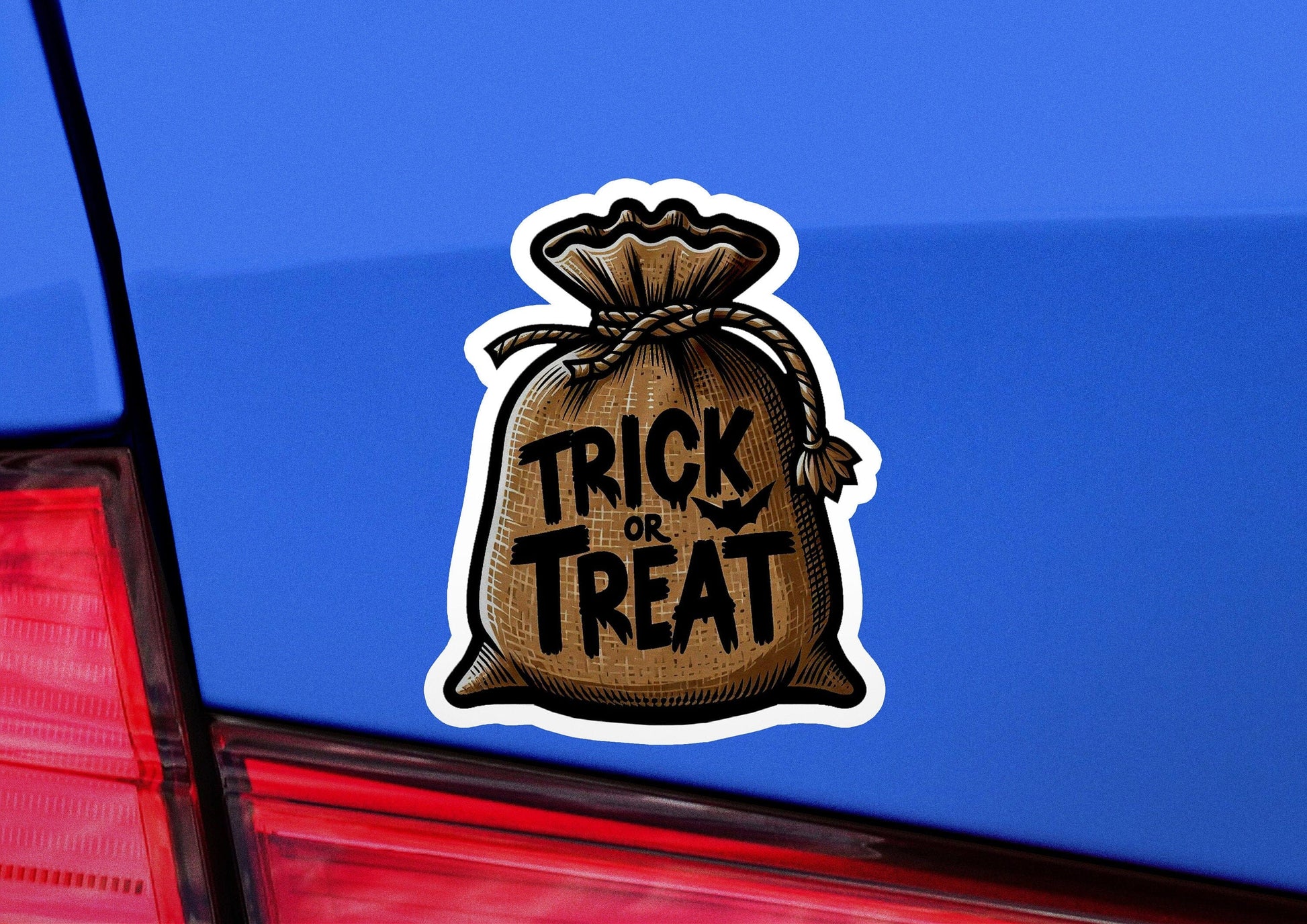 a sticker on the back of a car that says trick or treat