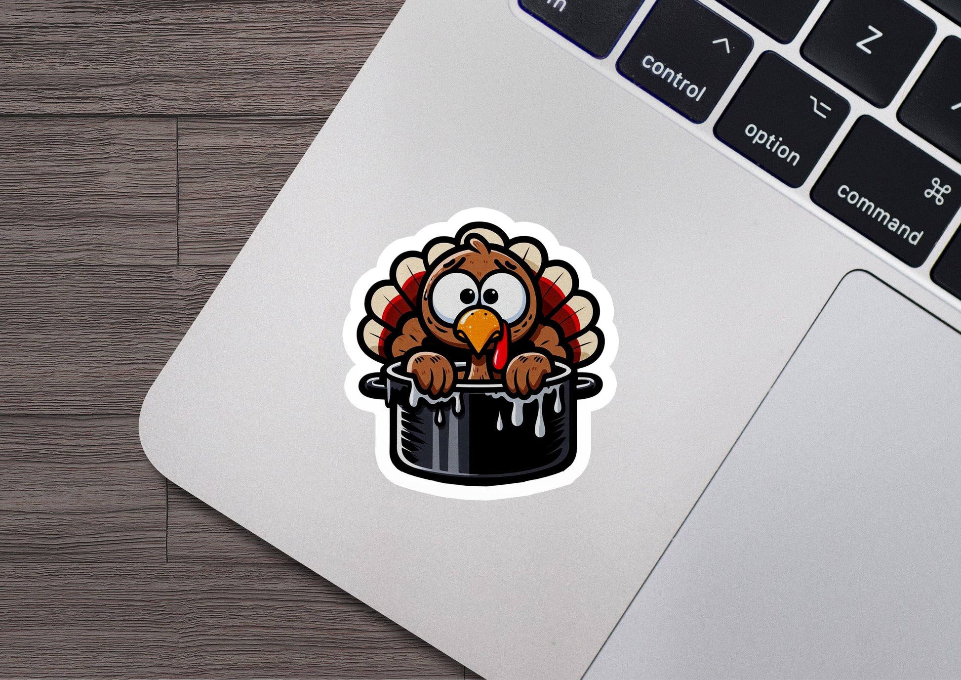 a sticker of a turkey sitting on top of a laptop