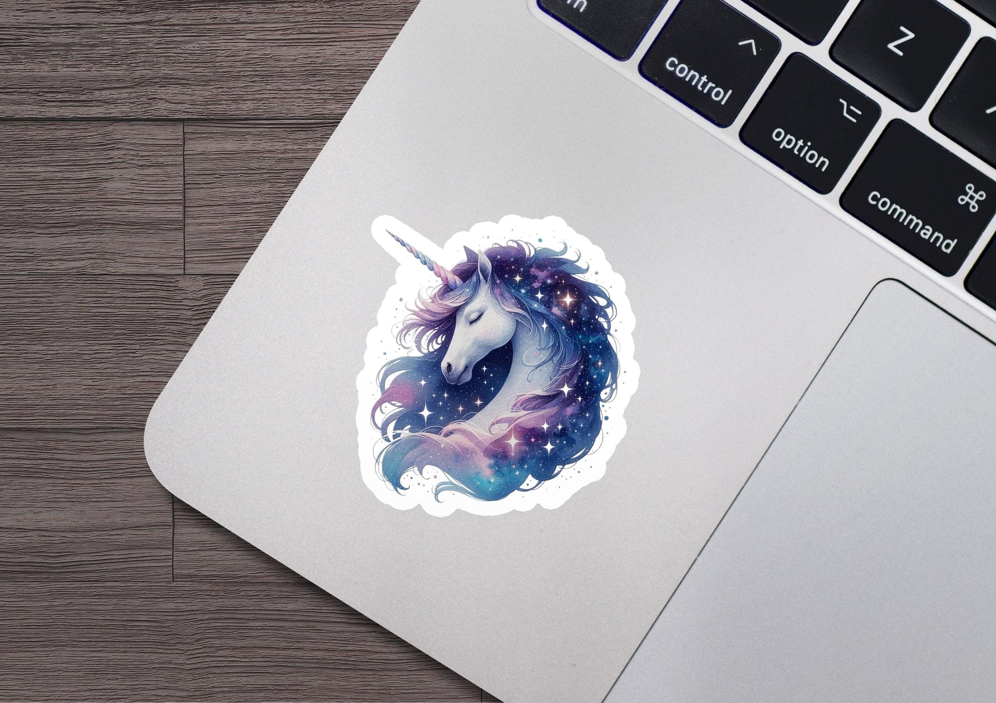 a laptop with a sticker of a unicorn on it