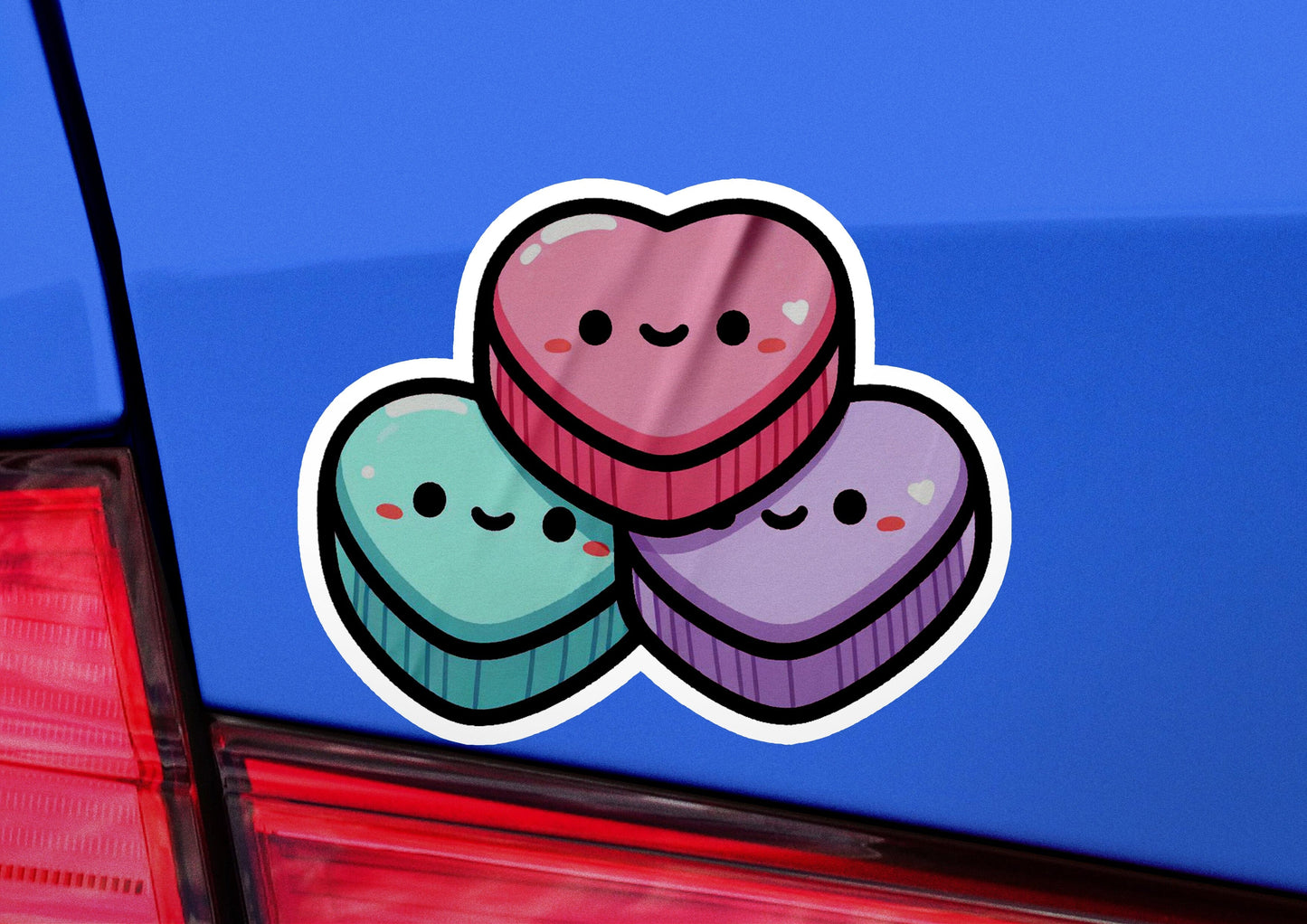 a sticker of two heart shaped cupcakes on the back of a car