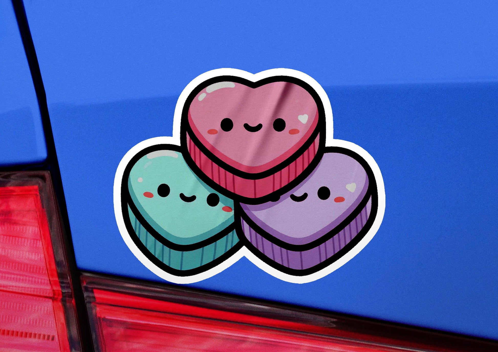 a sticker of two heart shaped cupcakes on the back of a car