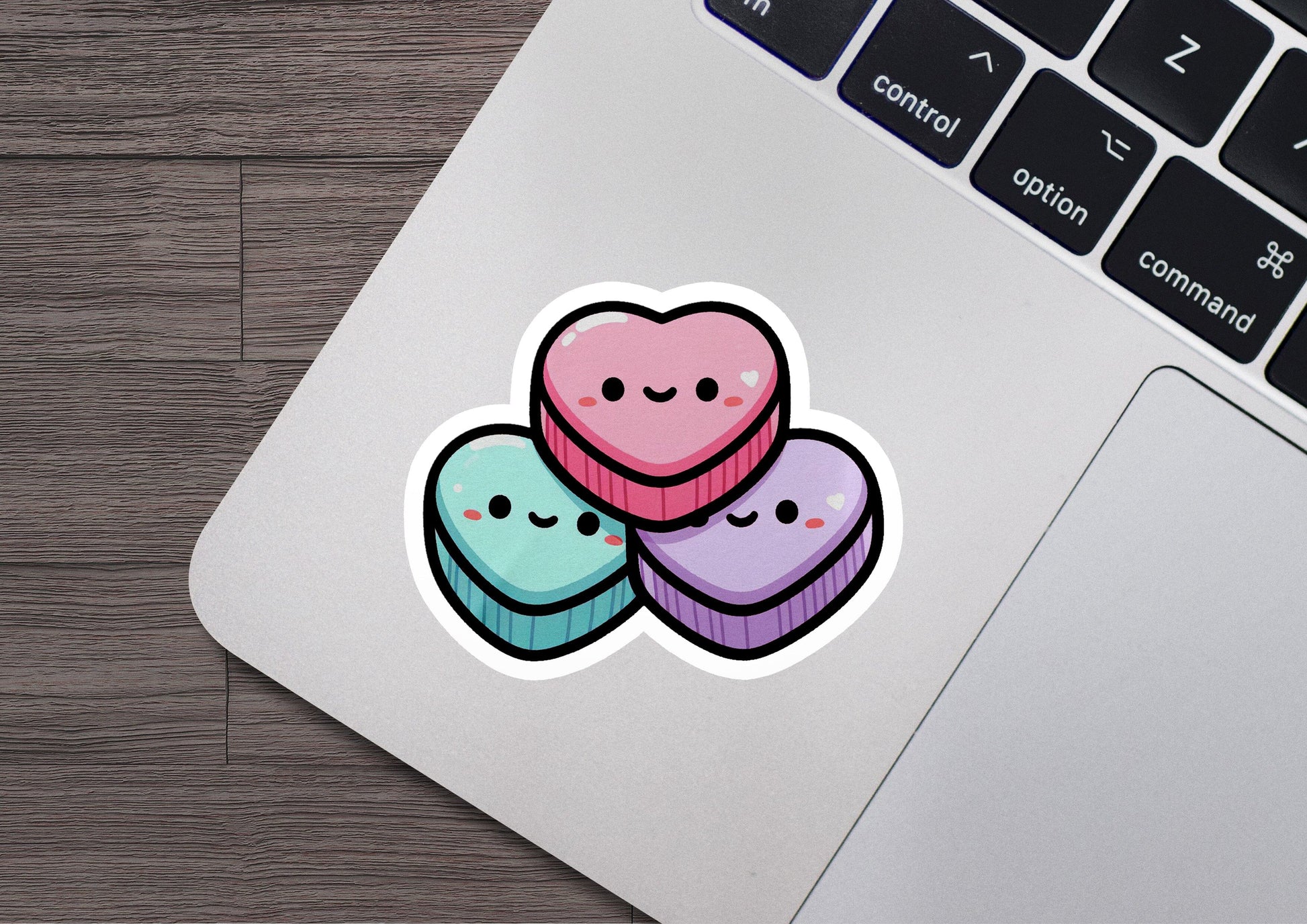 a laptop computer with a sticker of two heart shaped donuts