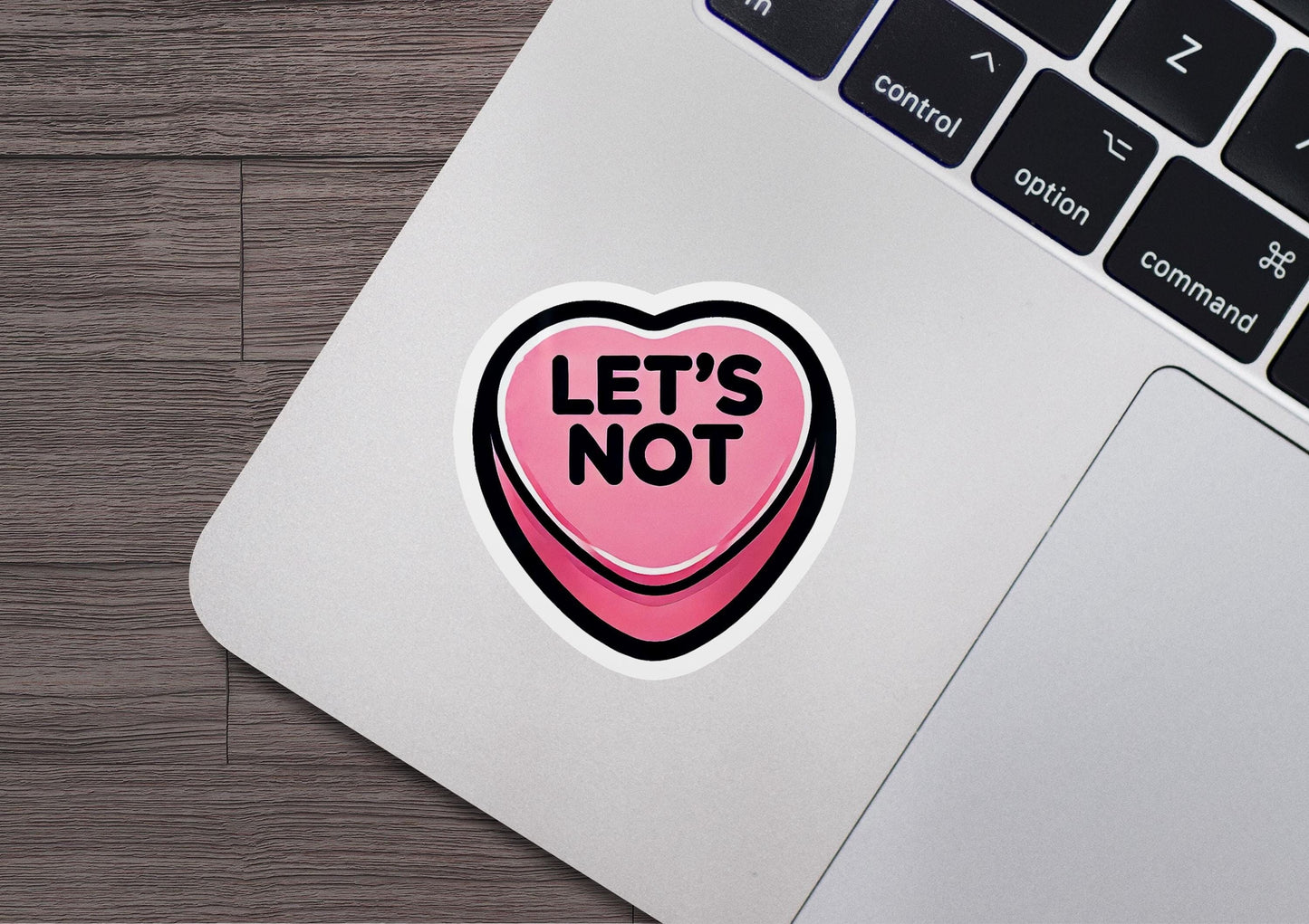 a sticker that says let's not on a laptop