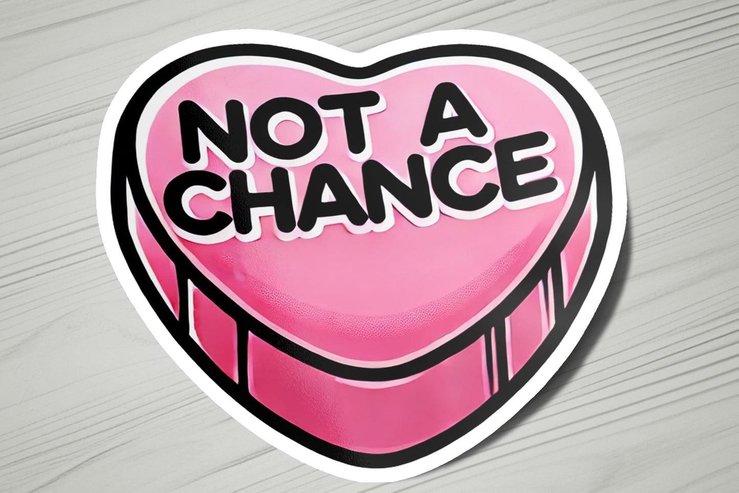 a heart shaped sticker with the words not a chance on it