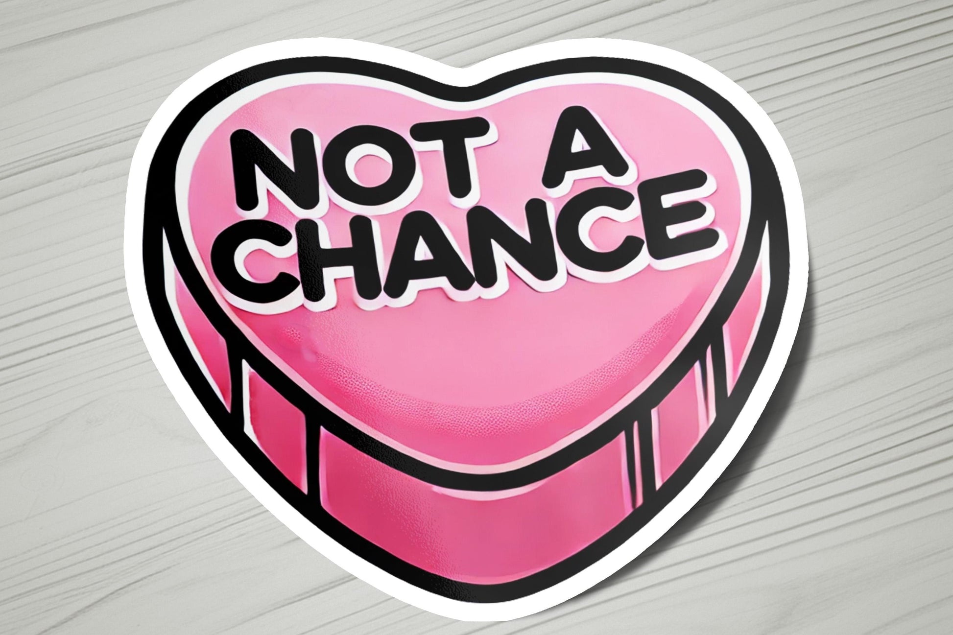 a heart shaped sticker with the words not a chance on it