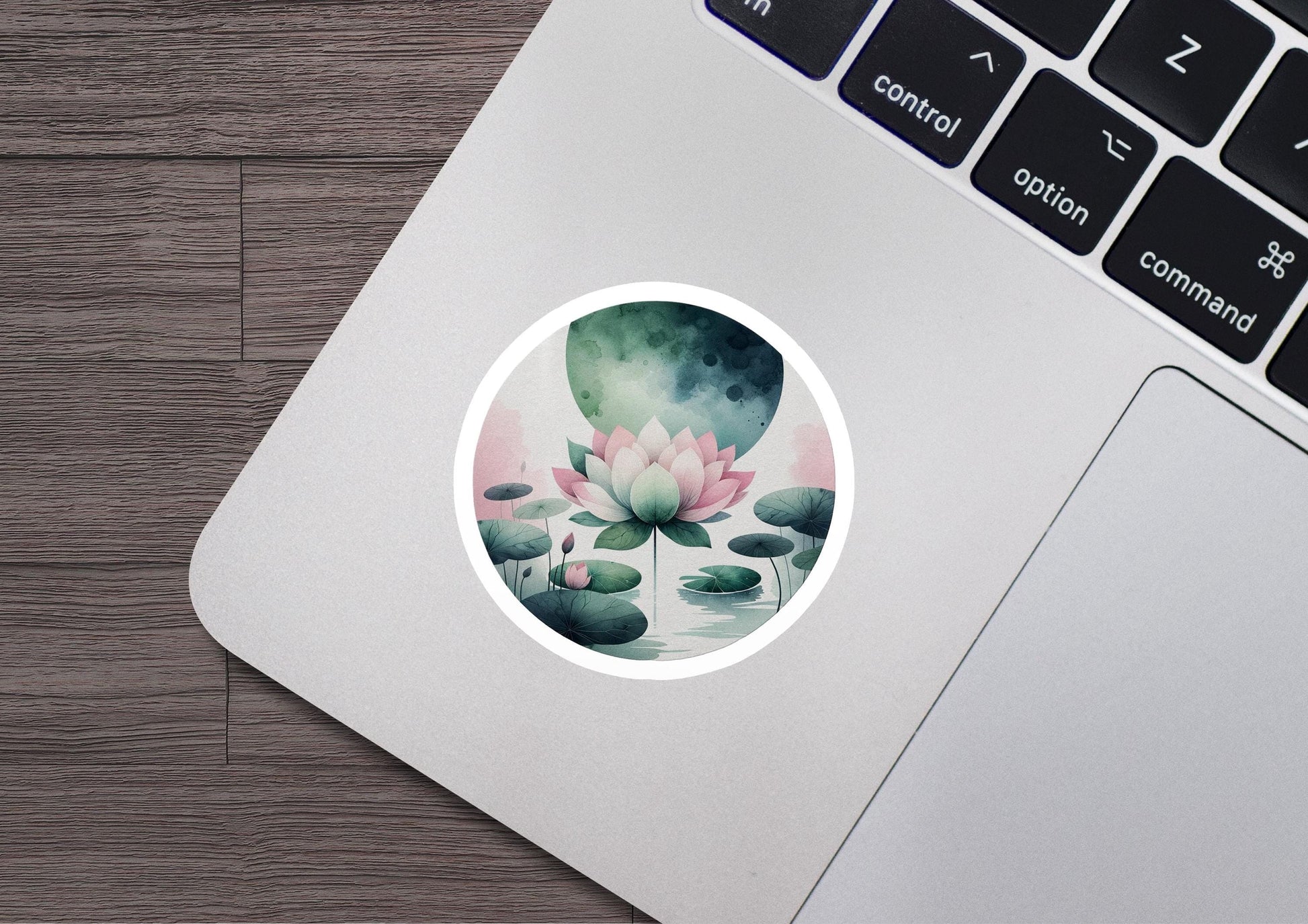 a laptop with a sticker of a water lily